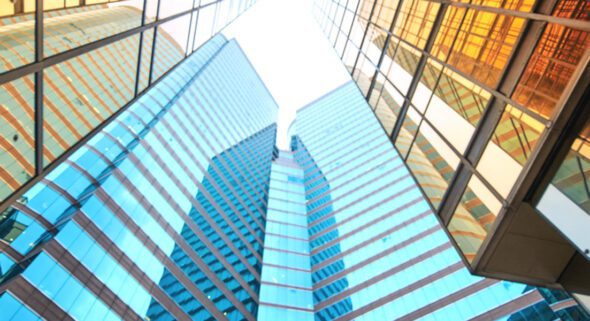 looking up at modern skyscrapers in business district