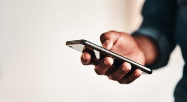 Man checking his iPhone for text messages