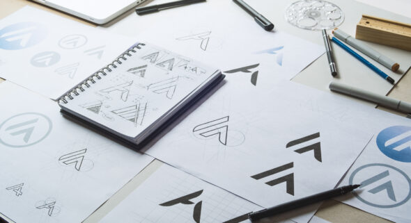 Graphic designer sketching logo concepts