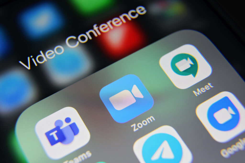 Video conference app icons on iPhone screen