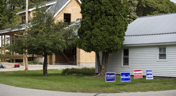 Trump-Pence yard sign and other political yard signs on a street in Michigan