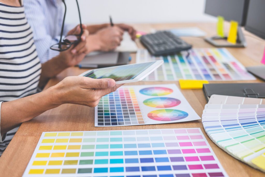 Creative team having a meeting in creative office, Architectural drawing with work tools and accessories, Color swatch samples chart for selection coloring