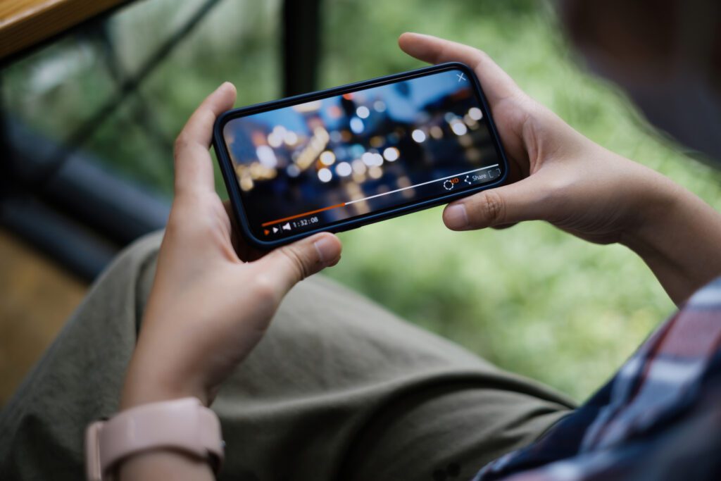 Person watching streaming content on their mobile device