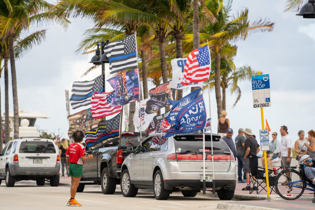 Vehicles on Fort Lauderdale Beach with President Trump support flags