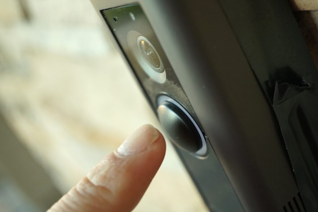 close up of a person's hand ringing a doorbell