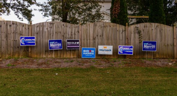 Democratic campaign signs along the side of the road near a polling location